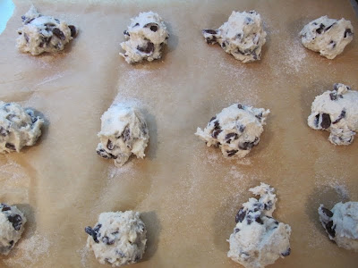 cherry chocolate chip scones batter on a cooking sheet on parchment paper.