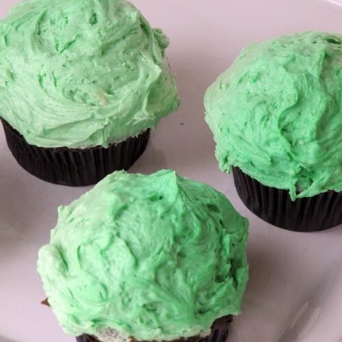 chocolate cupcakes made with guinness topped with green frosting.
