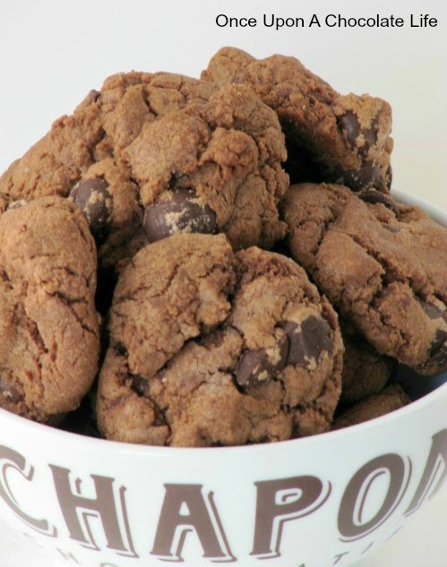 Large pile of double chocolate chip cookies in a white ceramic bowl