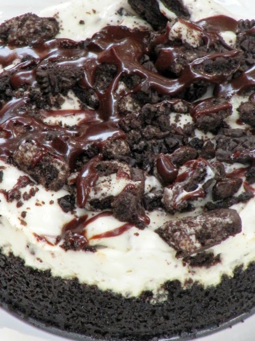 closeup of fudge topped no bake oreo cheesecake with oreo crust.