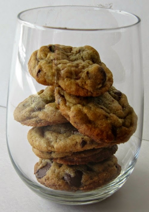 Glass jar filled with a stack of the best chocolate chip cookies ever.