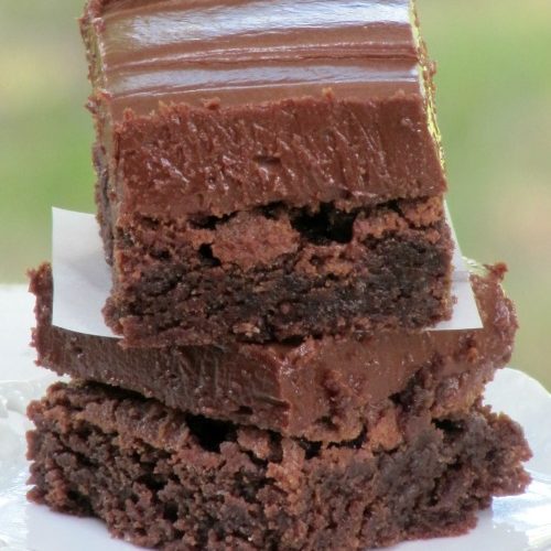 stack of fudgy brownies made with trisha yearwoods recipe including a chocolate coconut frosting.