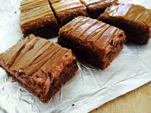 overhead view of several large thick lunch lady chocolate brownies with creamy chocolate frosting.