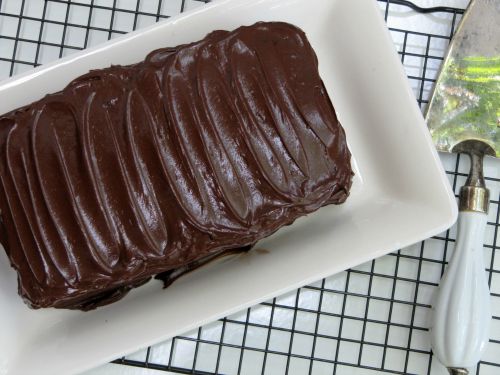 Top view of Beatty's Chocolate Cake with chocolate buttercream frosting on a white platter