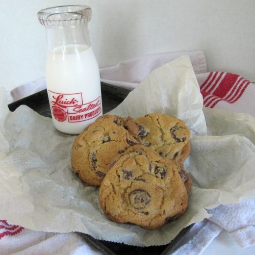 plate with chocolate chip cookies made from williams sonoma recipe by glass of milk.