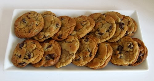 horizontal view of a rectangular white tray filled with two rows of large crispy on the outside soft inside Jacques Torres The Best Chocolate Chip Cookies Ever.