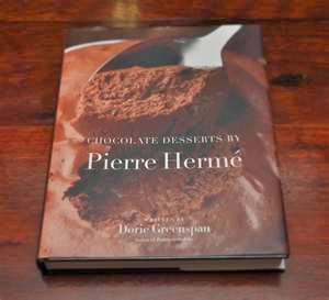 Overhead view of the cover of a recipe book by Pierre Herme containing chocolate recipes, such as Chocolate Chaud Pierre Herme.