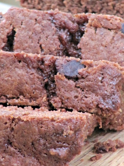 Closeup image of sliced chocolate chocolate chip banana bread made with cocoa powder and chocolate chips.