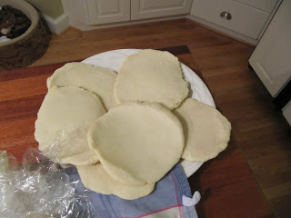 An overhead view of several uncooked dough disks in preparation to make chocolate cranberry rugelach cookies.