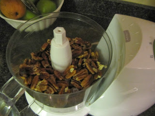 An overhead view of a Cuisinart filled with filling mixture for chocolate cranberry rugelach that includes chocolate chips, nuts, and dried cranberries.