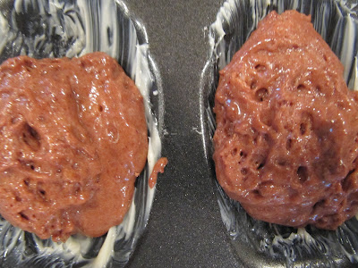 A closeup overhead view of raw chocolate batter for Chocolate Madeleines or Madeleines au Chocolat in a madeleine tin.