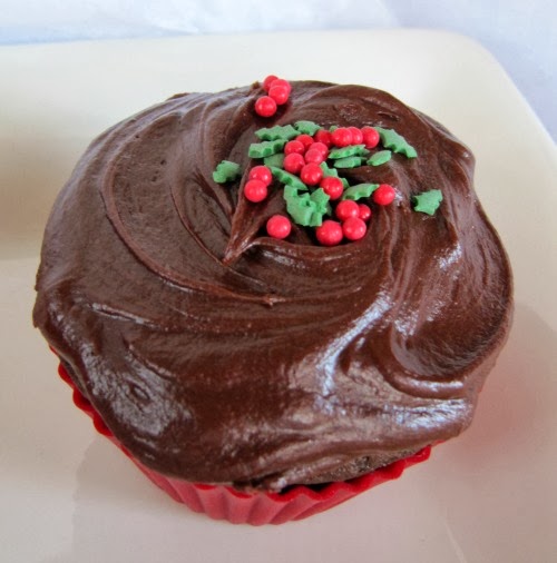 Closeup of one Chocolate Gingerbread Cupcake with Hershey's Perfectly Chocolate Frosting and red and green sprinkles.