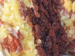 A closeup image of Chocolate Velvet Cake with Fudge Filling and Coconut Pecan Frosting.