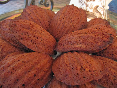 Closeup view of a plate of Chocolate Madeleines or Madeleines au Chocolat.