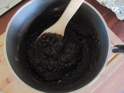 Chocolate batter for making Browned Butter Brownie Recipe from Bon Appetit is shown in a saucepan with a wood spoon.