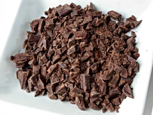 square white ceramic dish filled with chopped dark and milk chocolate, the ingredients in Chef MIndy Segal's Hot Chocolate Master Blend for making hot chocolate.