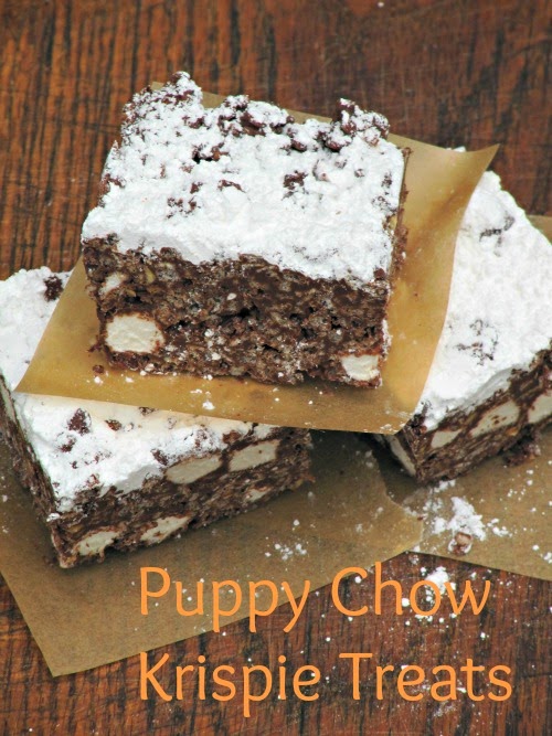 Top view of three rich chocolate puppy chow krispie treats showing marshmallows in a chocolate cereal and peanut butter base and a dusting of powdered sugar on their tops. The bars are on a brown wood surface.