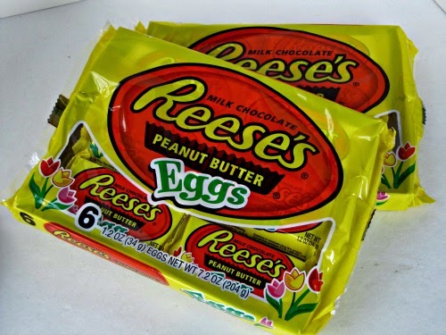 Two yellow and orange packages of Reese's peanut butter Eggs candy sitting on a white background, ready to make Chocolate Reese's Peanut Butter Egg Cookies.